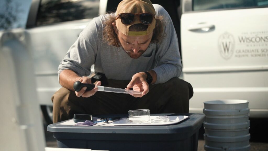 Researcher looking at water in a dish