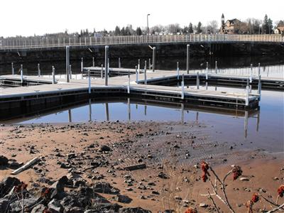 Piers in lake made inaccessible by excess lake sediment